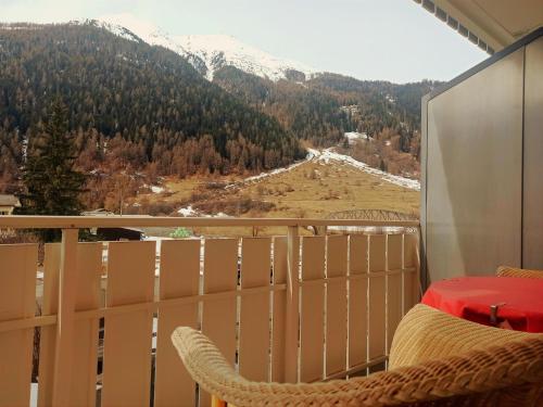 a balcony with a view of a snow covered mountain at Hotel Acla Filli in Zernez