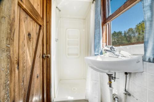 a bathroom with a sink and a shower at Edgewater Resort in Iron Mountain