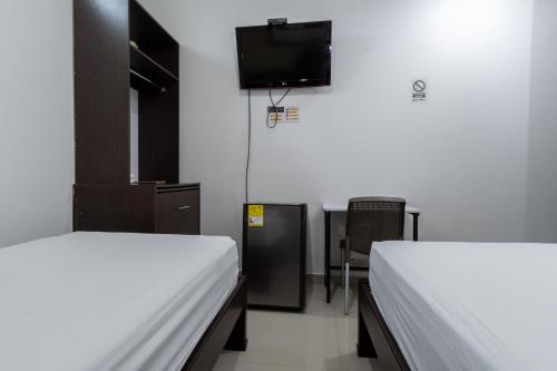 Un ou plusieurs lits dans un hébergement de l'établissement Genesis Hotel