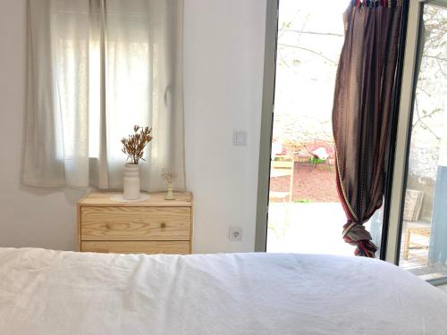 a bedroom with a bed and a dresser and a window at La Santa in Almagro