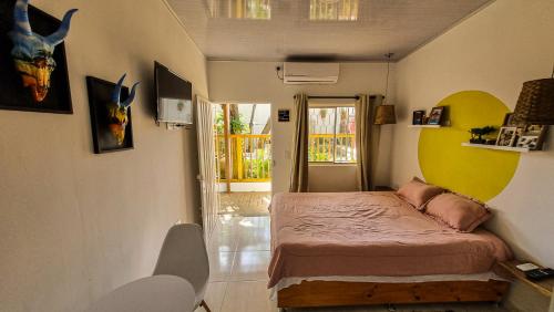 a small bedroom with a bed in a room at Guajira House in Ríohacha
