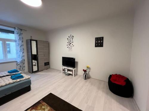 a living room with a bed and a flat screen tv at Smith House in Budapest