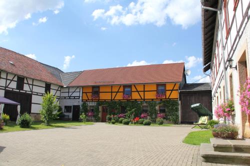 a courtyard of a building with flowers and plants at Pension Zumpe in Stolpen