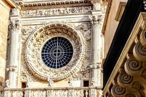 a clock tower with a window on the side of a building at Palazzo Quey in Lecce