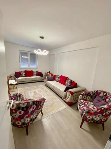a living room with two couches and two chairs at Lovely flat , full furnished with free parking in Prizren