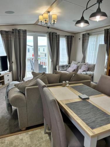 a living room with a couch and a table at Roadnights Retreat in Heysham