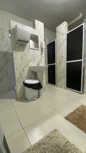 a bathroom with a toilet and a sink at Nomads Hostel Multicultural & Coworking in Salvador