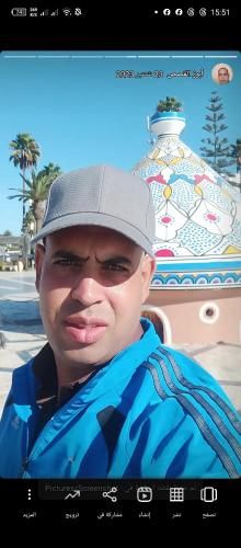 a young man wearing a hat and a scarf at Morocco in Safi