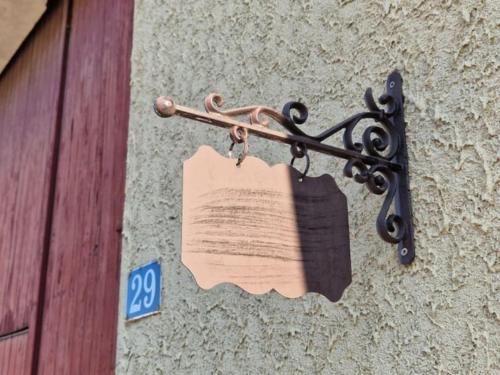 a piece of paper attached to the side of a building at Le Clos de chantecoq in Outrepont