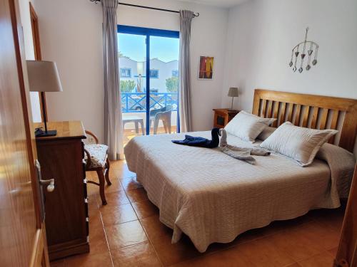 a bedroom with a bed with a dog sitting on it at Villa Valperal, en Lanzarote in Playa Blanca