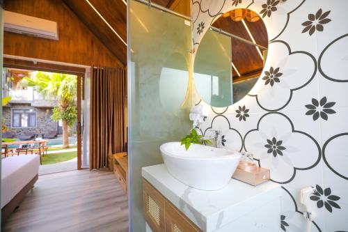 a bathroom with a sink and a mirror at Tam Coc Serenity Hotel & Bungalow in Ninh Binh