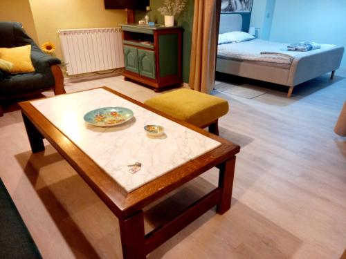 a living room with a coffee table and a bed at BLUE DEER in Umag