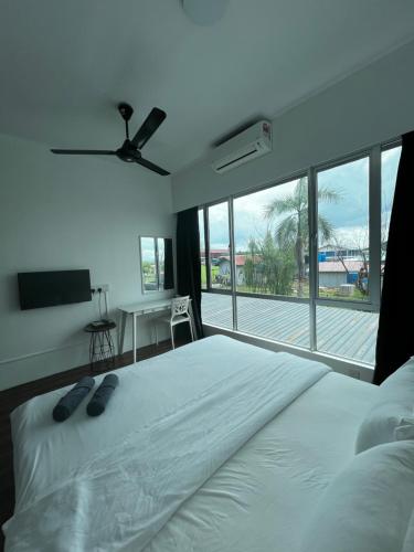 a bedroom with a large bed and a large window at SDC Suite Home II in Lahad Datu