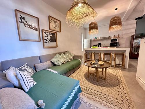 a living room with a blue couch and a table at Tolila Sidi Bou Said, grande terrasse avec vue in Sidi Bou Saïd