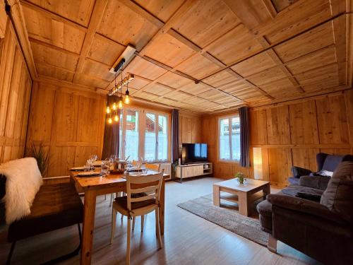 a living room with a table and a couch at Mountain Holiday in Wimmis