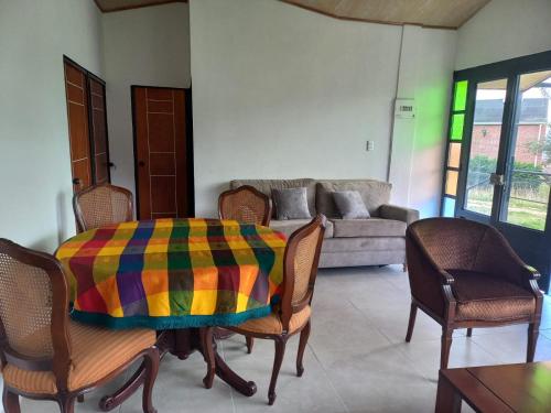 a living room with a table with a colorful blanket on it at San Miguel in Guatavita