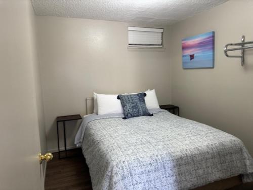 a bedroom with a bed with a blue pillow on it at Sunset Beach Resort in Osage Beach
