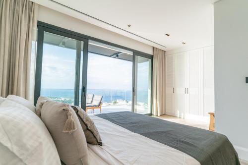 a bedroom with a large bed with a large window at Fuga Panorama in Bodrum City