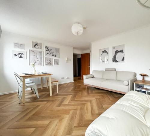 a living room with a white couch and a table at Stunning Central Flat w/ Parking in Bangor