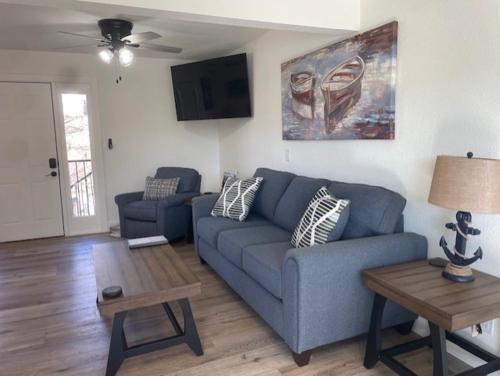 a living room with a blue couch and a table at Sunset Beach Resort in Osage Beach