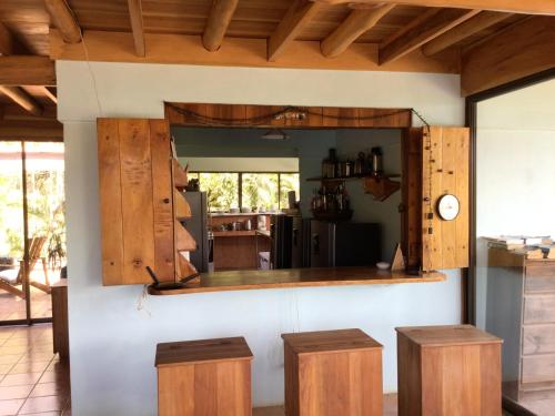 a kitchen with wooden cabinets and a counter with stools at Jodokus Inn in Montezuma