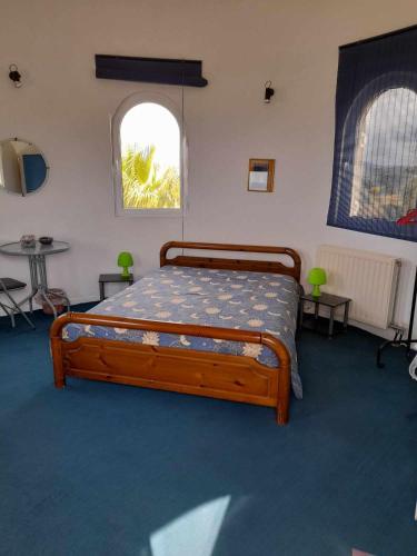 a bedroom with a bed in a room with a window at Charly Point Villa in Methoni