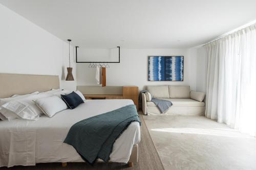 a bedroom with a large bed and a couch at Casa Malìa Luxury Guest House in Luz