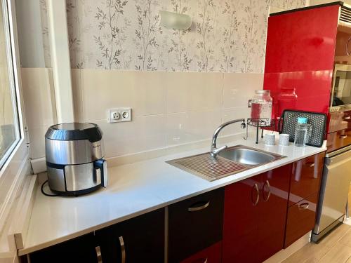 a kitchen with a sink and a coffee maker on a counter at Apartamento Las Canteras in Las Palmas de Gran Canaria