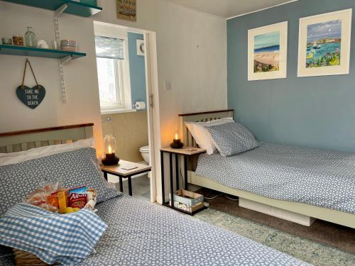 a bedroom with two beds and a toilet in it at Seaside Homestay - Ensuite twin room with Kitchenette in Paignton