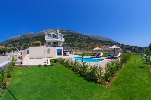 a house with a swimming pool in a yard at Kefalonia Horizon Villas in Ayia Evfimia