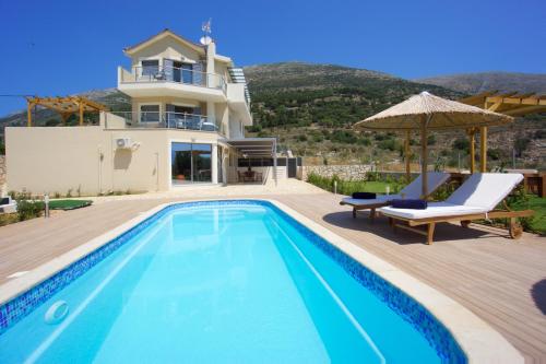 a villa with a swimming pool and a house at Kefalonia Horizon Villas in Ayia Evfimia