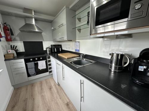 a kitchen with a sink and a counter top at Arthurs Escape in Filey