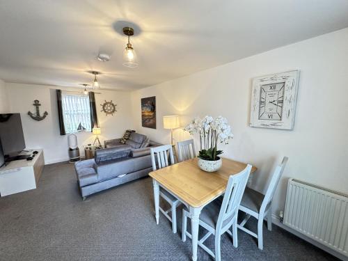 a living room with a table and a couch at Arthurs Escape in Filey