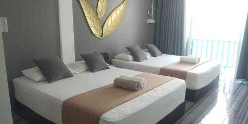 Säng eller sängar i ett rum på Perhentian Bay Chalet