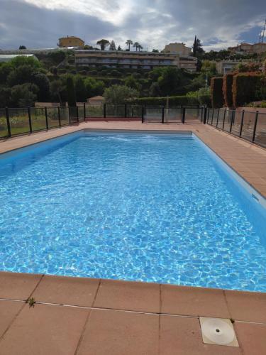 a large blue swimming pool on top of a building at Bel Azur in Saint-Laurent-du-Var