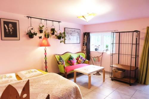 a bedroom with a bed and a chair and a table at Gîte du ruisseau in Épinal