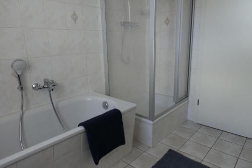 a bathroom with a shower and a bath tub at Apartment Annett in Senftenberg