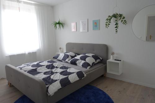 a bedroom with a bed with a black and white comforter at Apartment Annett in Senftenberg