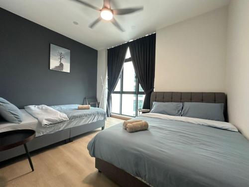 a bedroom with two beds and a ceiling fan at Cozy couple apartment suite in Masai