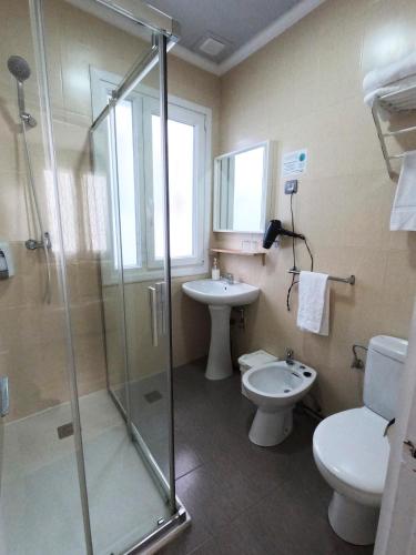 a bathroom with a shower and a toilet and a sink at Casual Gurea in Bilbao