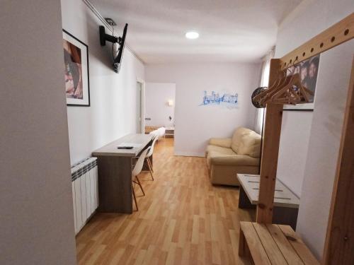 a living room with a table and a couch at Casual Gurea in Bilbao