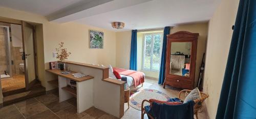 a room with a bedroom with a bed and a bathroom at Les Jardins de Falguière in Saint-Jean-du-Gard