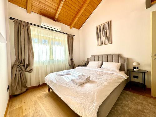 a bedroom with a large bed with a window at Blue Nest in Timişoara