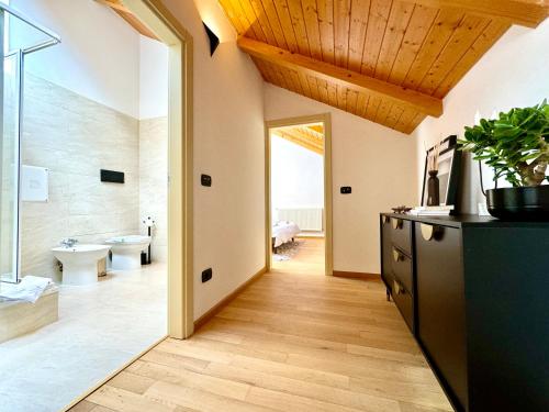 a bathroom with a wooden ceiling and a hallway at Blue Nest in Timişoara