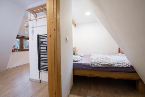 a small bedroom with a bed in a attic at U Cejhonů in Měděnec