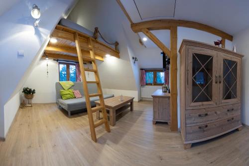 a living room with a loft bed and a couch at U Cejhonů in Měděnec
