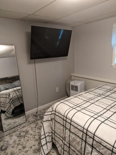 a room with two beds and a flat screen tv on the wall at ECLIPSE Vermont in Colchester