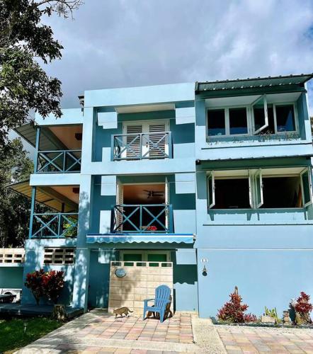 a blue building with a dog in front of it at Hacienda Verde Luz La Casona in La Jurado