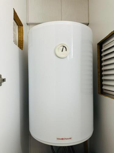 a white refrigerator freezer sitting in a room at North Residence Havuz Manzaralı Daire in Kérynia