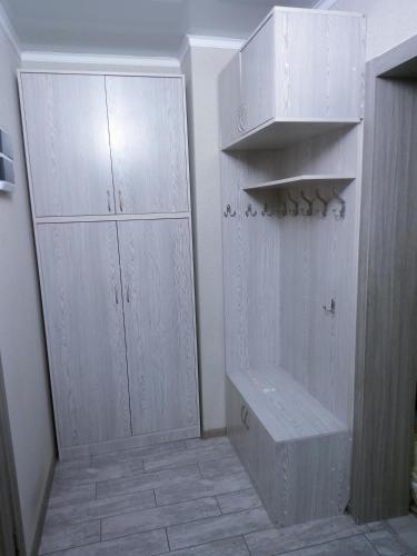 a room with white cabinets and a tiled floor at Уют в сердце Алматы in Almaty